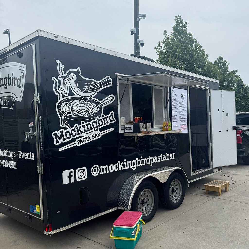black and white food truck in parking lot