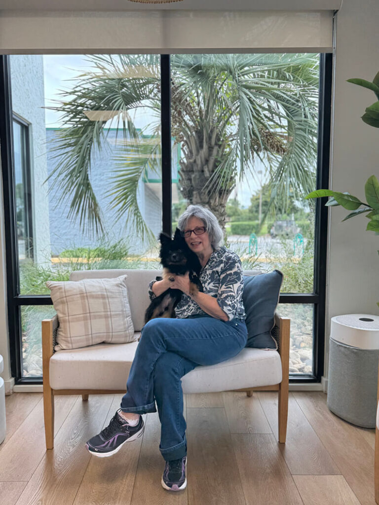 One lady holding a medium black dog called Bucky.