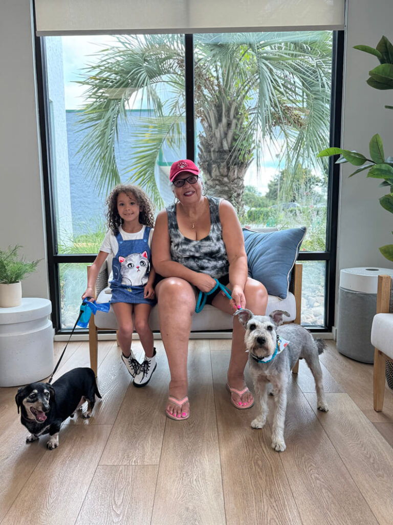 August 2025 adoption of Zero a gray terrier mix. Family of 2 with a black Dachshund mix.