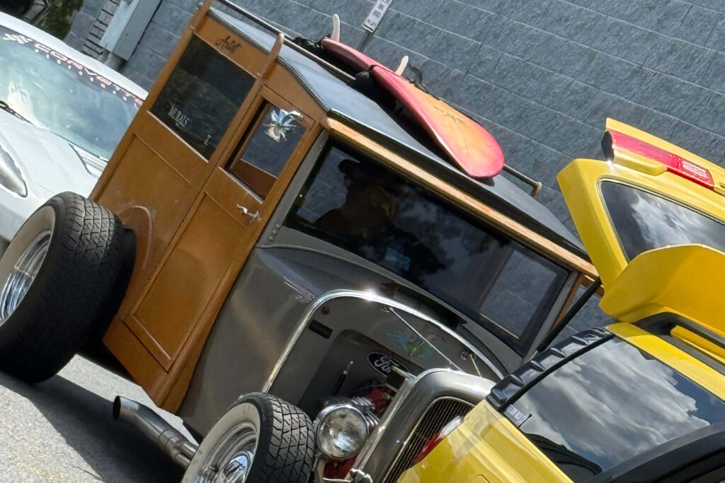 brown and black car with surf board on top