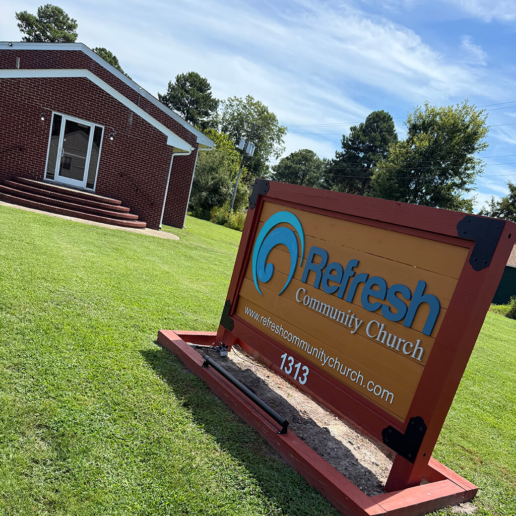 Refresh Community Church sign in front of the church building with website and address