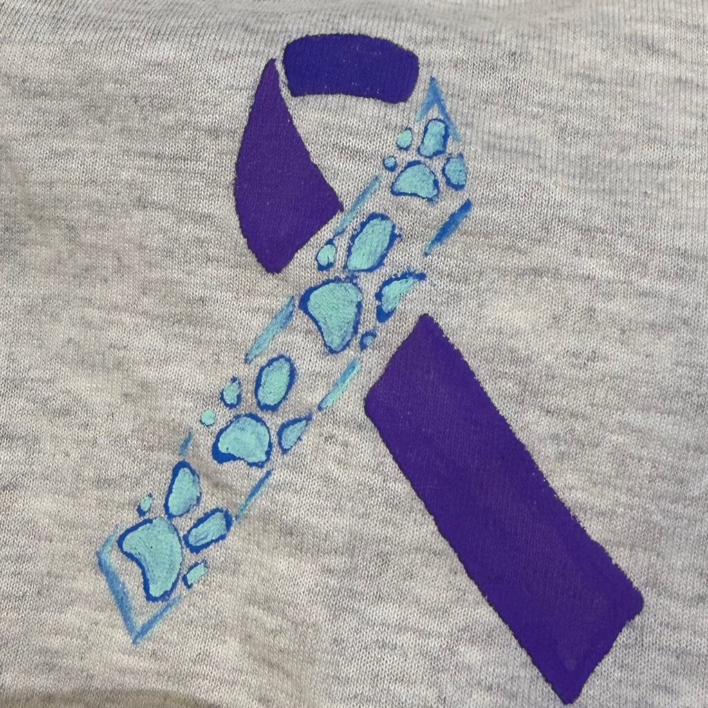 The purple and teal ribbon with paw prints on it.