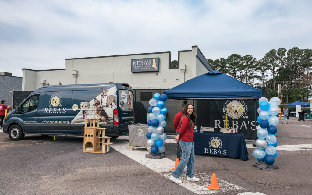 Reba's Animal Rescue and Adoption Center store back and entrance to event. Balloons and the van decorated the area for donation collection.