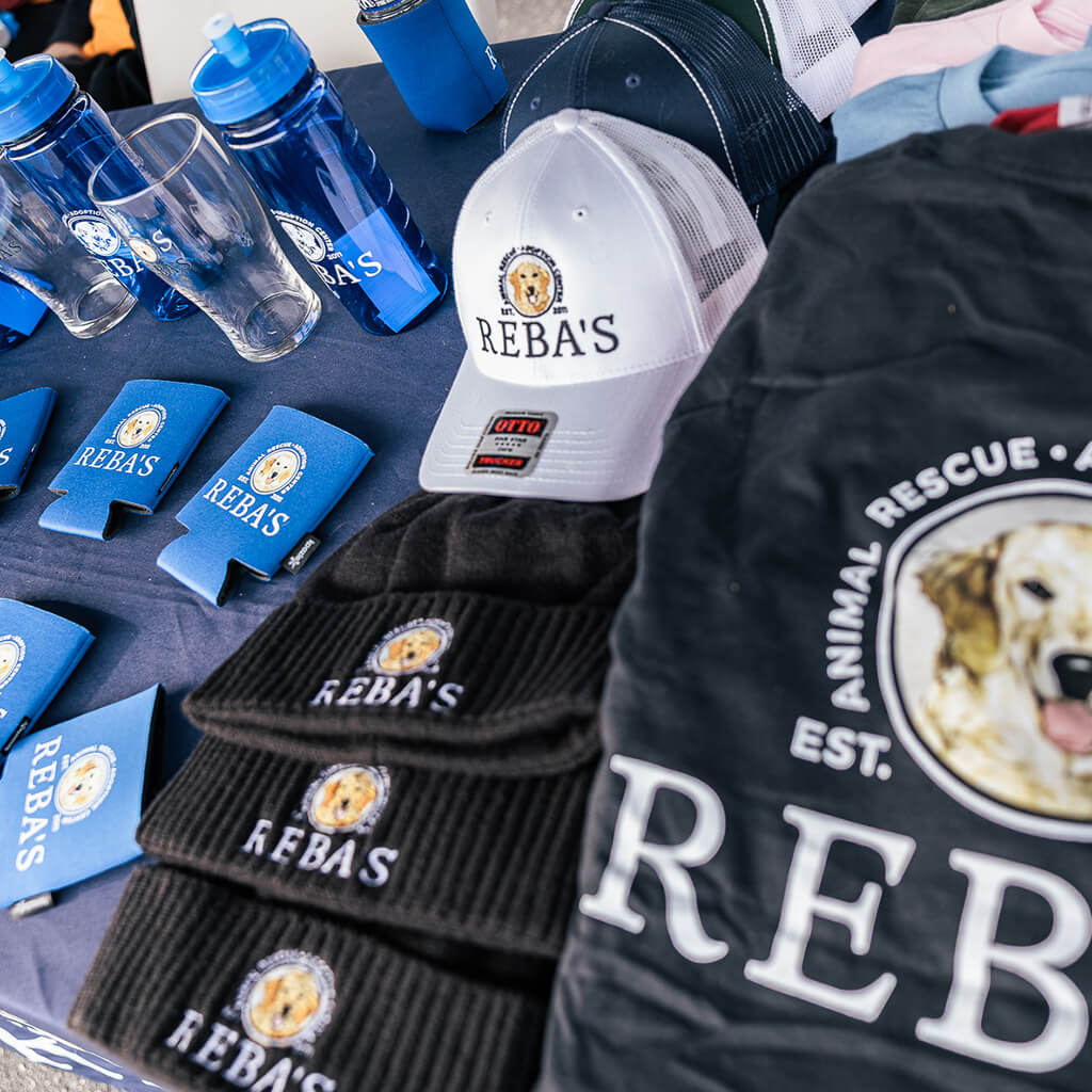 Reba's merchandise November 2025 includes hats, beanies, shirts, water bottles, glasses, doozies, frisbees, and stickers