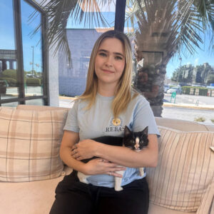 Staff photo of Elissa with adoptable cat.
