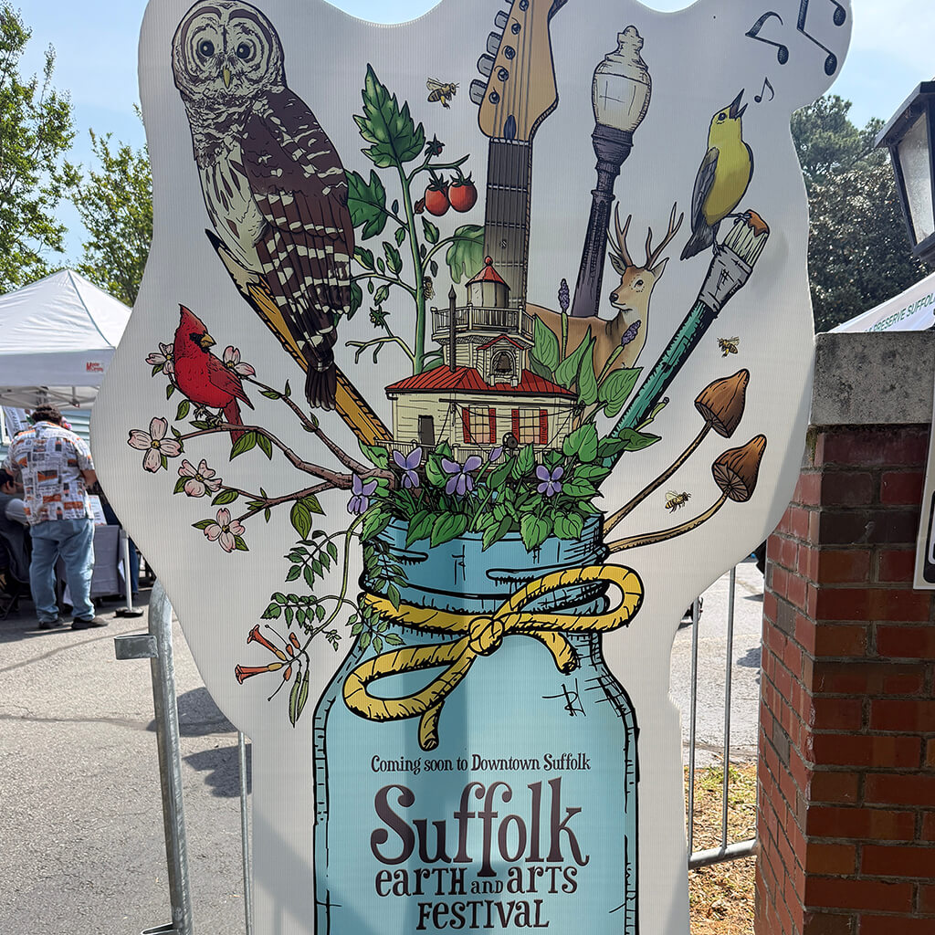 Large cutout poster of the Suffolk earth and arts festival logo