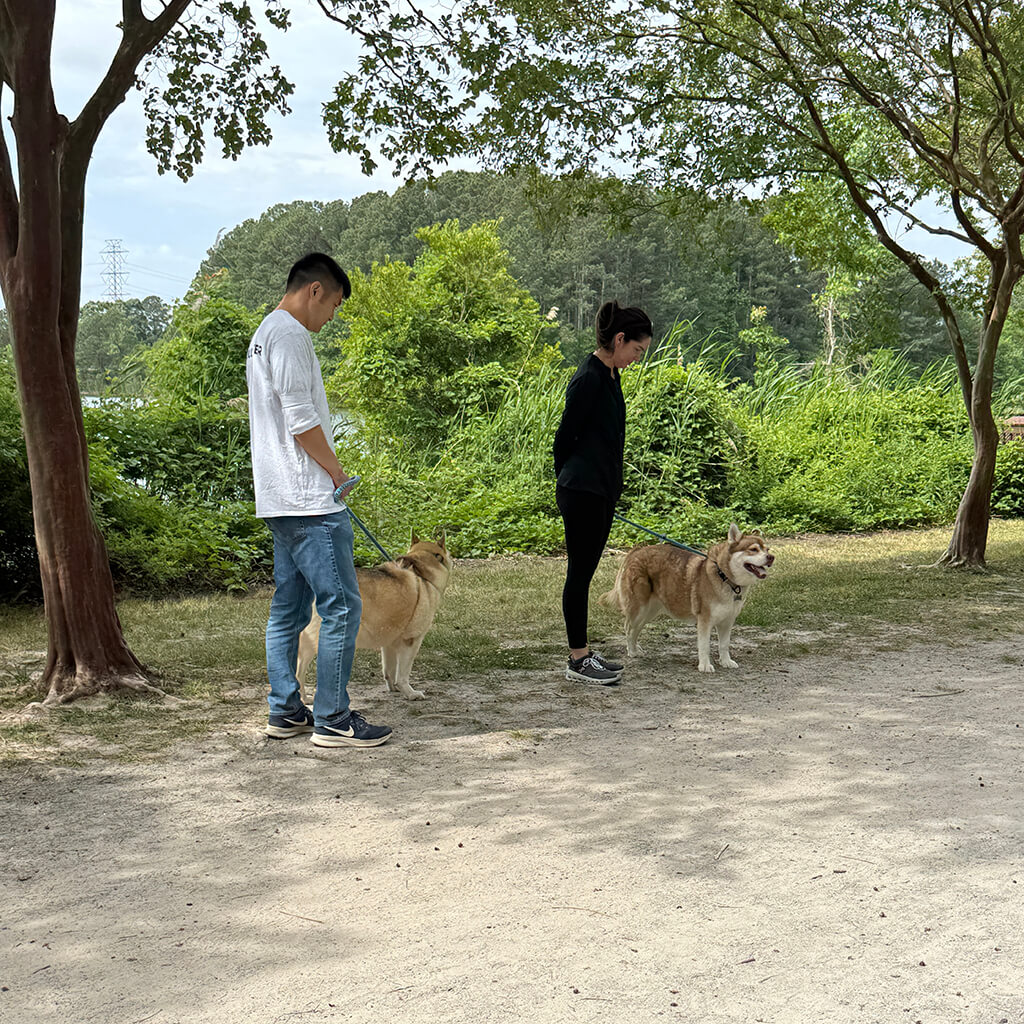 May 8th Road Trip with the Coast Guard - Two volunteers walking with babe and buster