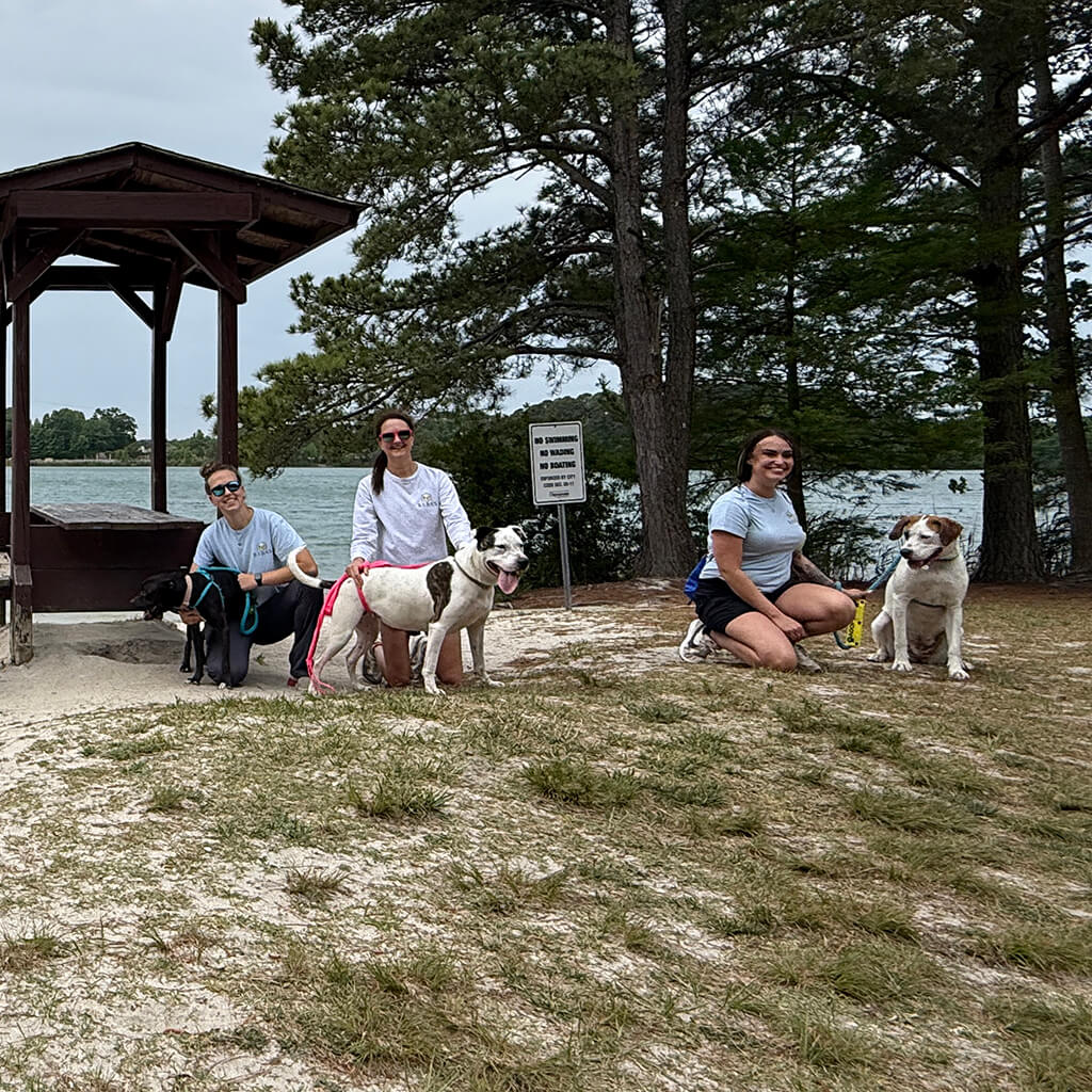 May 8th Road Trip with the Coast Guard - three volunteers on the beach with the dogs