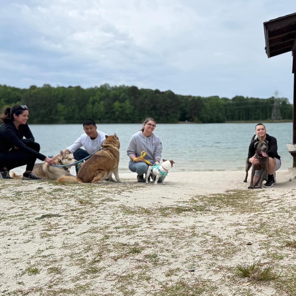 May 8th Road Trip with the Coast Guard - four volunteers on the beach with the dogs