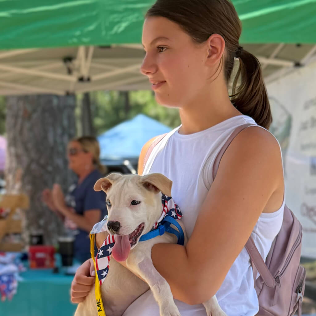 Girl holding the white dog